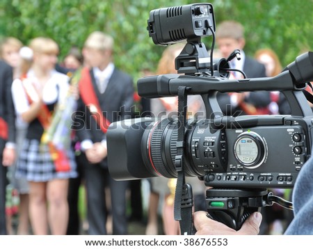 Final examinations. School-leaving party (graduation party).Operator recording a holiday on a video camera.