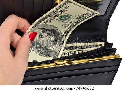 Female hand takes the dollar bill one hundred dollars from a black purse isolated on a white background