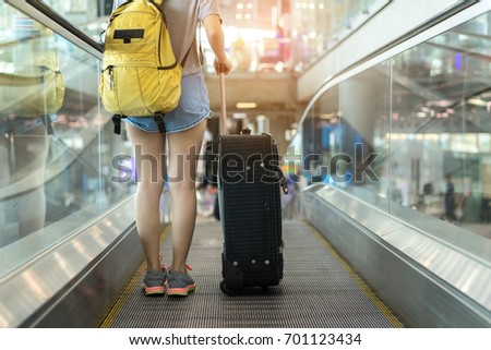 Young girl asian traveler walking with carrying hold suitcase luggage and passenger for tour travel booking ticket flight in airport international vacation time in holiday rest and relaxation.
