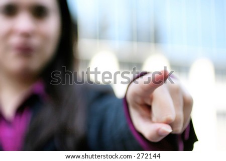 Woman pointing. Finger tip in focus.