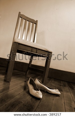 Shoes sit prepared for the days events in anticipation at the foot of a chair