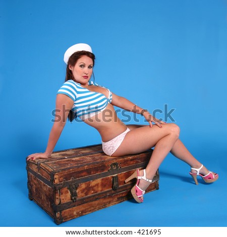 Sailor girl sitting on an old wodden trunk. Done in a modern pin-up style