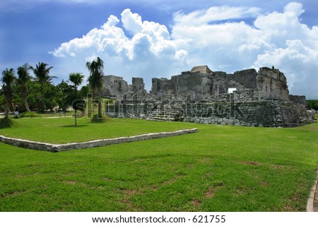 Mayan ruins in Tulum Mexico. Dramatic clouds paint a scene of an past time.