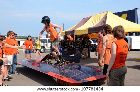 ANN ARBOR, MI - JULY 16: Oregon State University\'s solar car team driver exiting the car at the American Solar Challenge stop July 16, 2012 in Ann Arbor, MI.