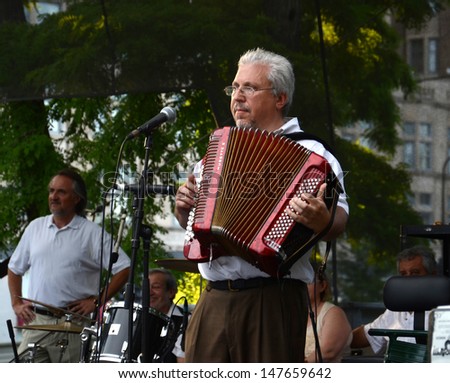 CHICAGO - JULY 18: Peter Sadkhin, accordionist and band leader of Tum Balalaika Klezmer band, plays at SummerDance in Grant Park on July 28, 2013.