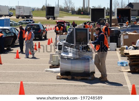 ANN ARBOR, MI - APRIL 26:  A worker wraps a pile of electronics at an electronic recycling event in Ann Arbor, MI April 26, 2014.