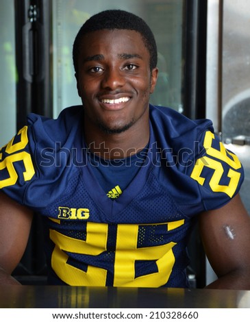 ANN ARBOR, MI - AUGUST 10:  University of Michigan football player Jourdan Lewis pauses between autographs at Michigan Football Youth Day on August 10, 2014 in Ann Arbor, MI.