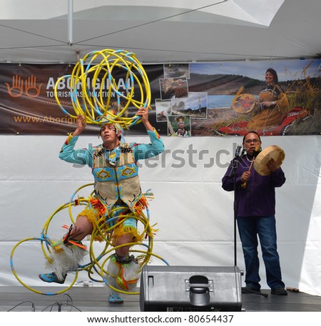 VANCOUVER, BC - JUNE 26:  World-champion Hoop Dancer Alex Wells concludes his performance at the National Aboriginal Awareness Celebration, June 26, 2011 in Vancouver, BC.