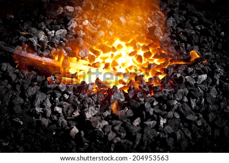 Conceptual image of a hot iron in burning coals