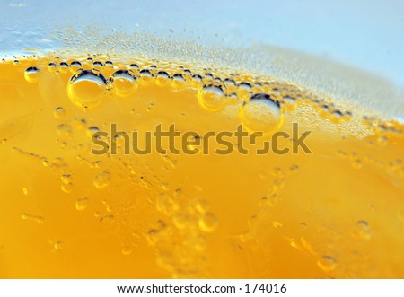Macro shot of bubbles in yellow liquid