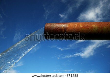 clean water coming out of an old rusted pipe