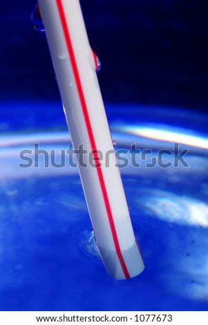 Close-up of drinking straw submerged - focus on submerged frontmost part of straw