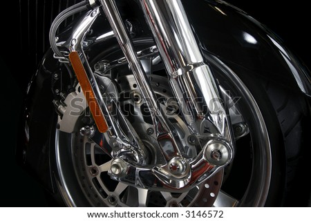Close up of a chrome rim and wheel on a big motor bike