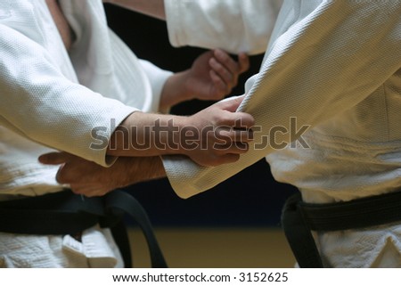 Judo fighters sparring off in a battle of body and mind - selective focus and visible grain
