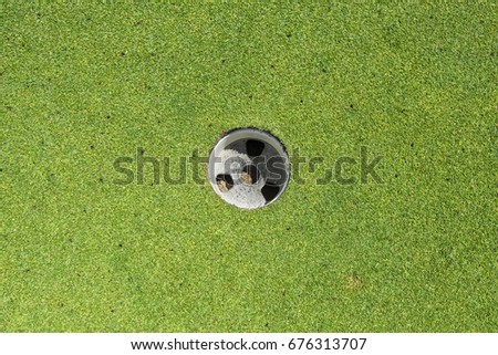Golf hole on the putting green
