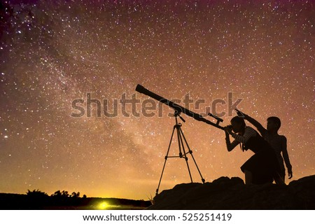 Boys and girls telescopic. Milky Way galaxy, rice paddy fields and mountains. Long exposure photograph, with grain.Image contain certain grain or noise and soft focus.