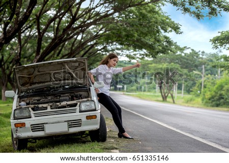 Young woman seeking help His car engine crash