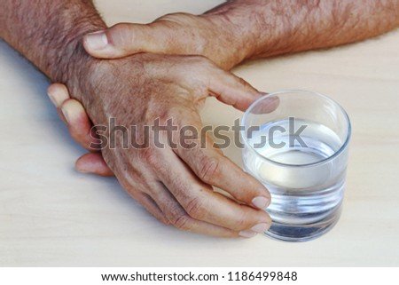The hands of a man with Parkinson\'s disease tremble. Strongly trembling hands of an older man