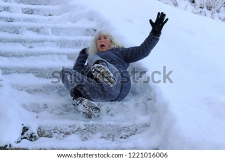 A woman slipped and fell on a wintry staircase. Fall on smooth steps