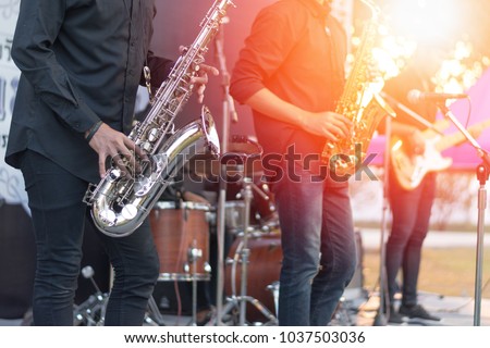 World Jazz festival. Saxophone, music instrument played by saxophonist player and band musicians on stage in fest.