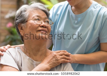 Nursing home with caregiver and old lady resident concept.Care giver hand on happy elderly senior patient to comfort in hospital or hospice nursing home or hospice county.