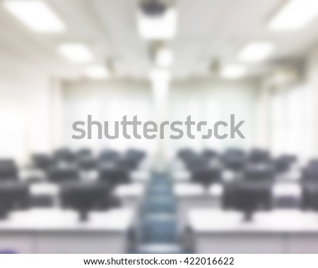 Blurred abstract background of empty computer room with rows of PC in university. Blur view of computer class with nobody in school.