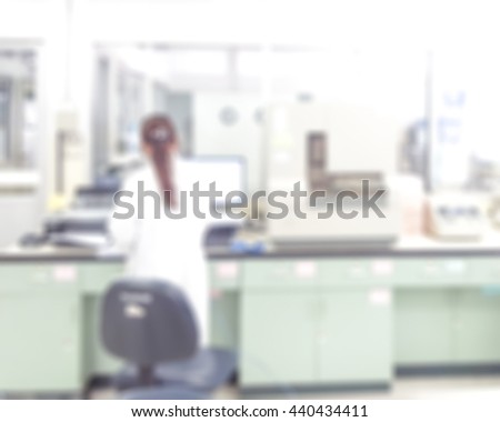 Blur abstract background of female scientist working in university research laboratory. Blurry view of lab technologist test specimen in science room. Defocus chemist work in laboratory in hospital.