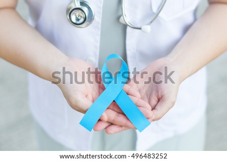 Female doctor in white uniform hold light blue ribbon awareness in hand for Addisons Disease,Behcets Disease,Chronic Illness,Hyperaldosteronism,Lymphedema,Men\'s Health,Prostate cancer,Thyroid Disease