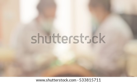 Blur abstract background work space with doctor dentist working on dental care clinic with child kid patient's oral checkup: Blurry view hospital clinical room space with equipment instrument