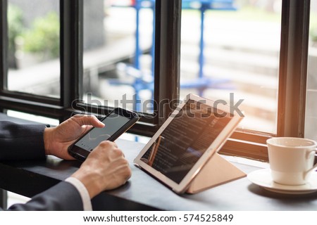 Business man using multichannel services on laptop computer in vintage coffee shop. City lifestyle business man hands working on typing keyboard using  4G 5G wifi internet online communication.