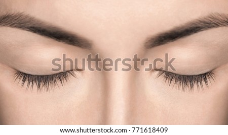 A beautiful woman with unextinguished eyelashes in a beauty salon. Eyelash extension procedure