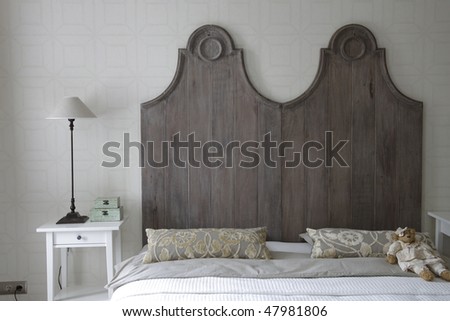 big bed with high headboard in gray color