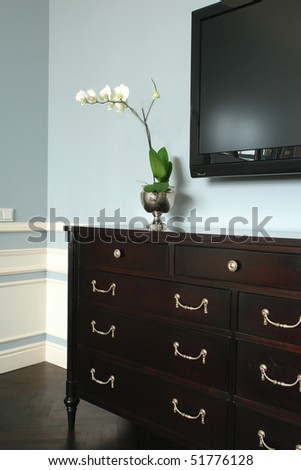 white flowers on the chest of drawers