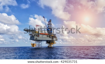 Oil and gas drilling rig working on remote wellhead platform to drill the oil and gas reservoir industry