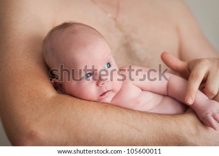 father holds his adorable 1 months old baby