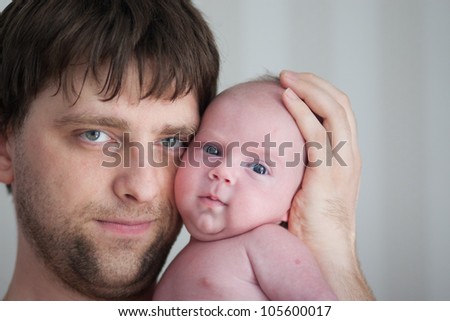 father holds his adorable 1 months old baby