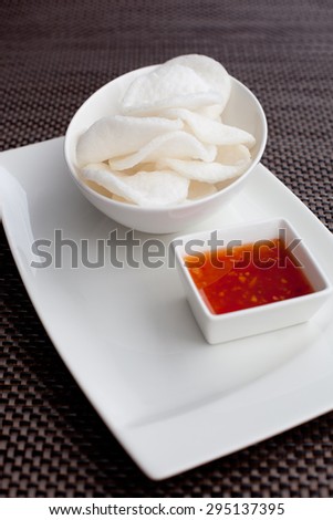 crisp rice, dish of crisp cracker with  sauce