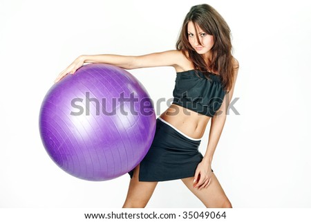 Young woman on white background in a fitness pose