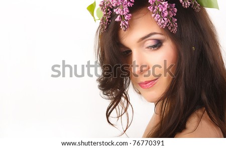 Beautiful, smiling women with lilac flowers in hair and with purple makeup  isolated on white background