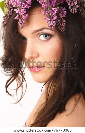 Beautiful, smiling women with lilac flowers in hair and with purple makeup  isolated on white background