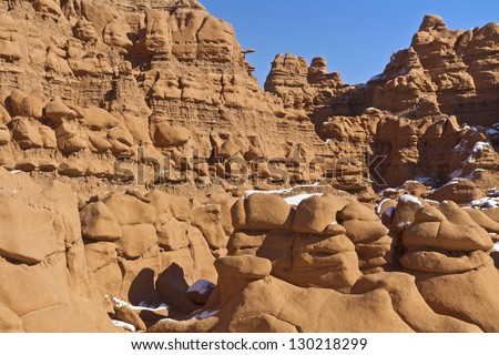 Dozens of sandstone  \'Goblins\' line the cliffs in snowy Goblin Valley State Park, Utah