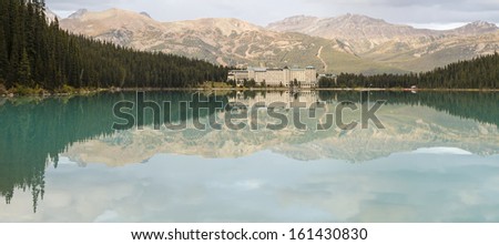 Chateau Lake Louise and the Lake Louise Ski runs reflected in the lake in Banff National Park, Alberta