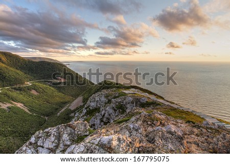 The winding Cabot Trail road seen from high above on the Skyline Trail at sunset in Cape Breton Highlands National Park, Nova Scotia