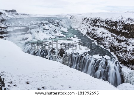 The two steps of Gullfoss form a half frozen triangle in the winter in Western Iceland