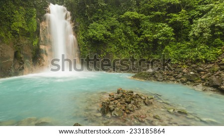 Panoramic image of the cerulean blue waters of the Rio Celste Waterfall in Volcan Tenoria National Park, COsta Rica.
