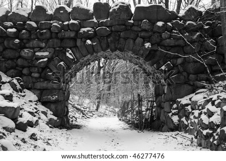 Black and white image of snowy Bridle Path and Boulder Bridge in Prospect Park, Brooklyn, New York