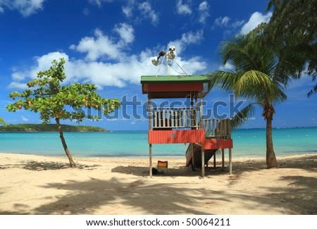 A lifeguard post stands in front of a calm aqua bay at Seven Seas Beach near Fajardo, Puerto Rico
