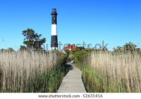 A winding boardwalk over the grassy marsh leads to the Fire Island Lighthouse Fire Island National Seashore, New York