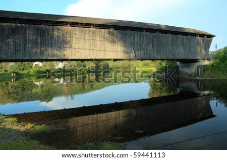 Historic Downsville Covered Bridge (ca. 1854) reflected in the East Branch of the Delaware River in the Catskills - New York
