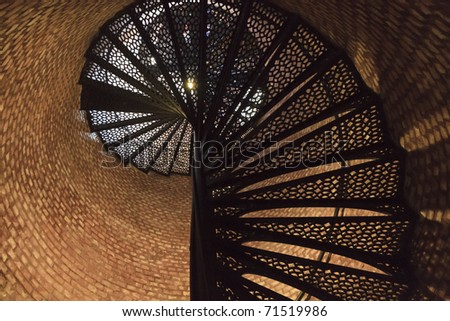 View of a spiral staircase from below remeniscent of a conch shell inside the Pensacola Lighthouse in Pensacola, FL